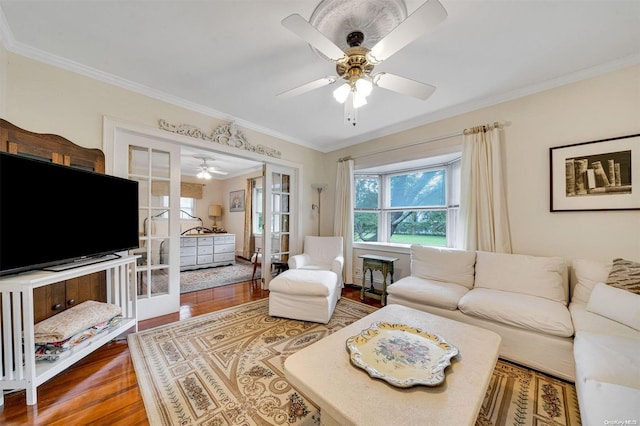 living room with hardwood / wood-style floors, ornamental molding, and french doors