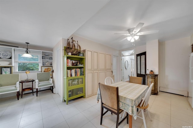 dining space with light tile patterned floors, a baseboard radiator, and ceiling fan