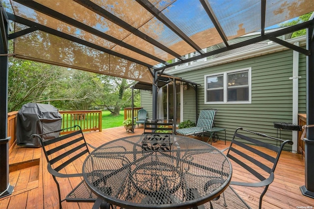 wooden deck with a pergola and a grill