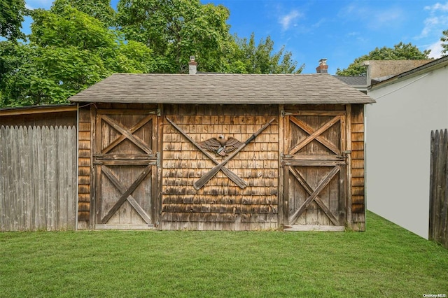 view of outdoor structure featuring a lawn