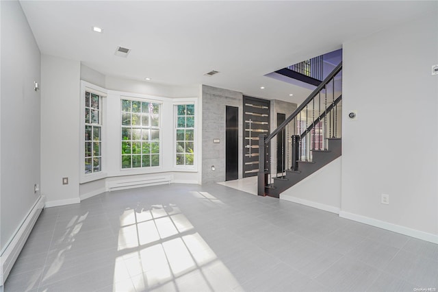 unfurnished living room featuring tile patterned floors and a baseboard heating unit