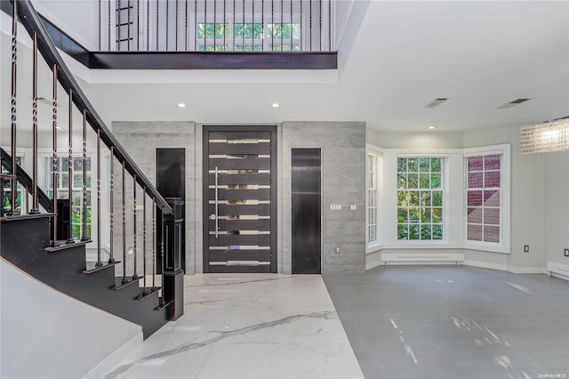 entryway featuring tile walls and a baseboard heating unit