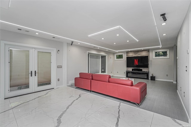 living room with french doors and a tray ceiling