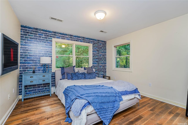 bedroom with dark hardwood / wood-style floors