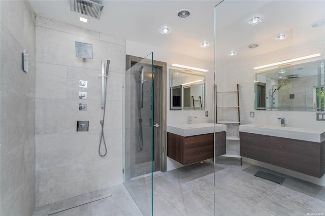 bathroom featuring a tile shower and vanity