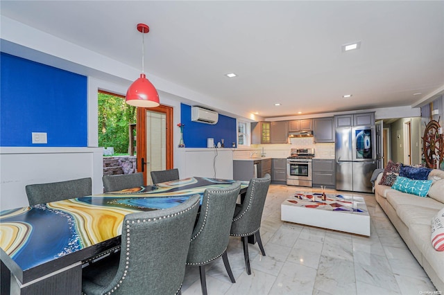 dining room featuring an AC wall unit and sink