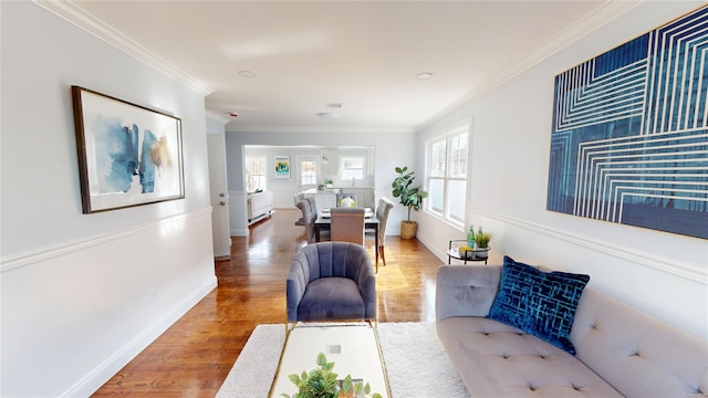 hallway with ornamental molding, baseboards, and wood finished floors