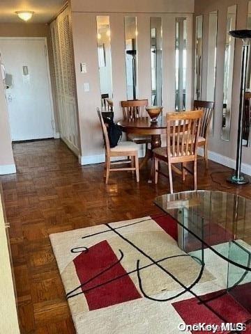 dining area featuring dark parquet floors