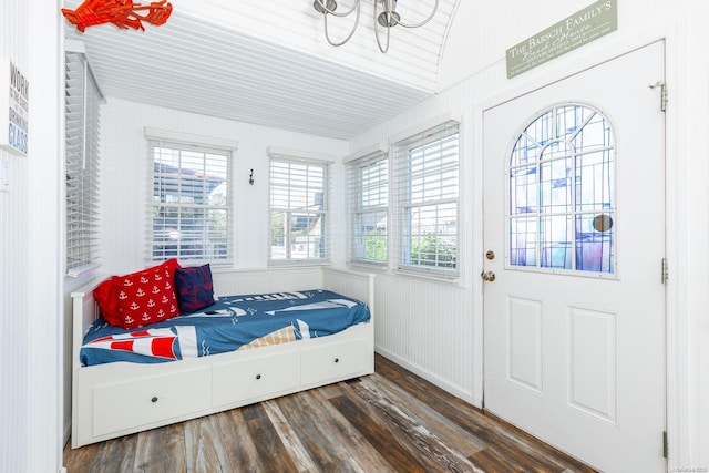 interior space with plenty of natural light, dark wood-type flooring, and vaulted ceiling