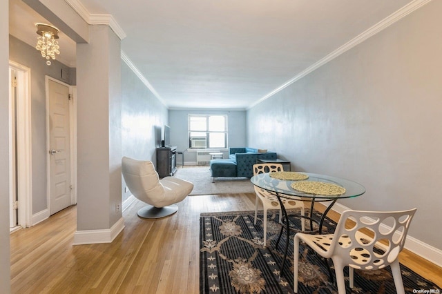 dining room featuring light hardwood / wood-style floors and ornamental molding