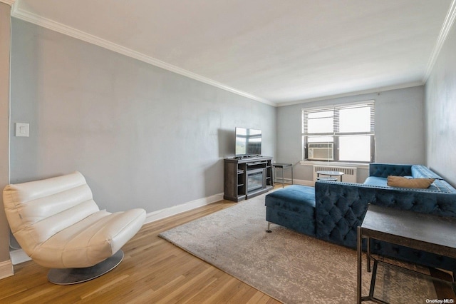 living room featuring wood-type flooring, cooling unit, radiator, and ornamental molding