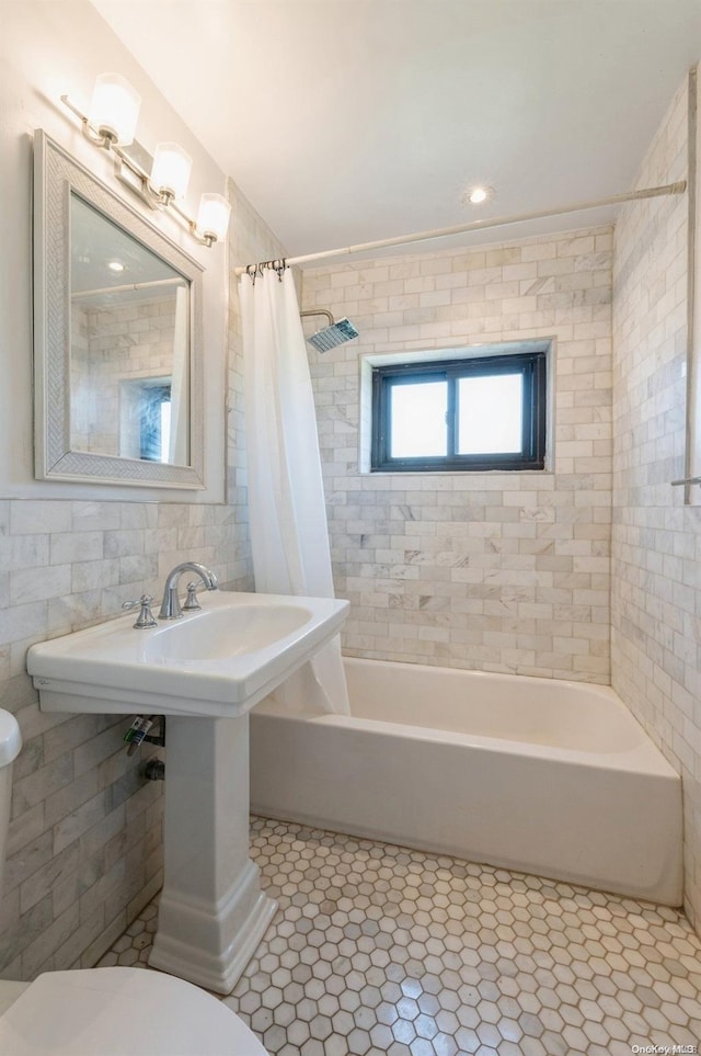 bathroom featuring tile patterned flooring, toilet, tile walls, and shower / bath combo with shower curtain