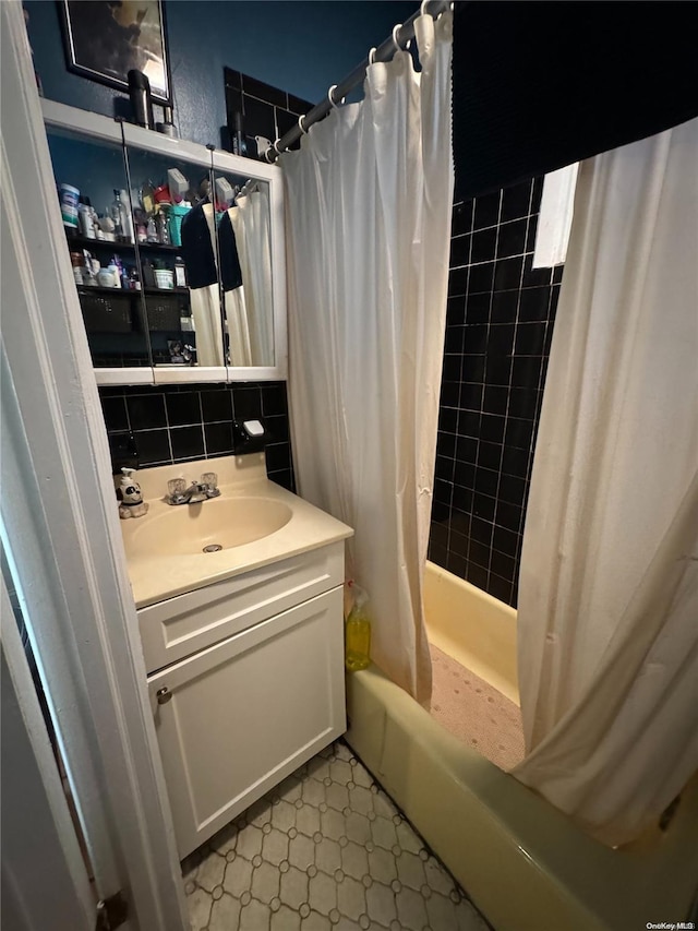 bathroom with tile patterned floors, vanity, backsplash, and shower / tub combo with curtain