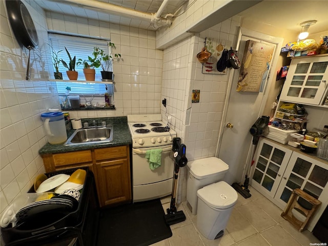 bathroom with tile patterned floors, tile walls, and toilet