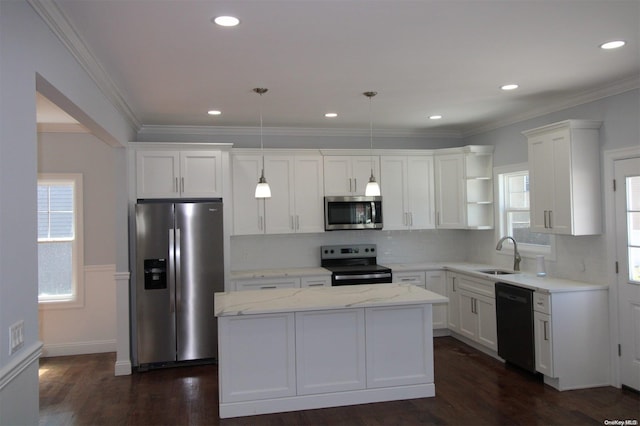 kitchen featuring dark wood-type flooring, hanging light fixtures, stainless steel appliances, light stone counters, and a kitchen island