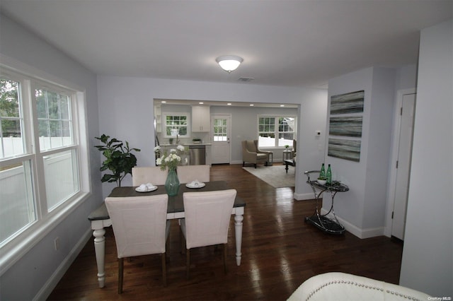 dining area with dark hardwood / wood-style flooring