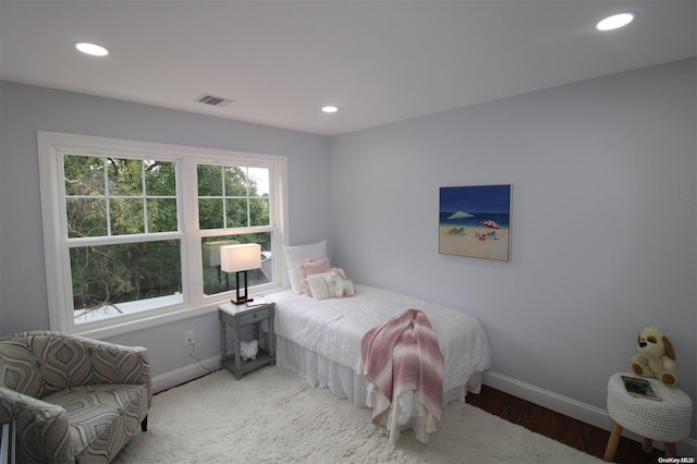 bedroom with hardwood / wood-style floors