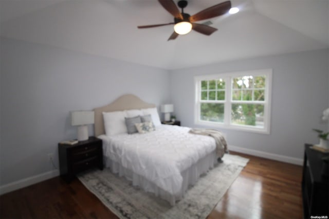 bedroom featuring ceiling fan, dark hardwood / wood-style flooring, and lofted ceiling