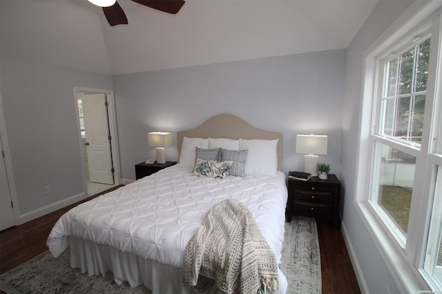 bedroom with ceiling fan, dark hardwood / wood-style flooring, and lofted ceiling