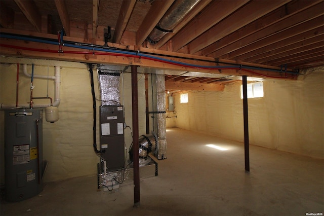 basement with electric water heater and electric panel