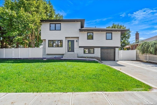 view of front of house with a garage and a front lawn