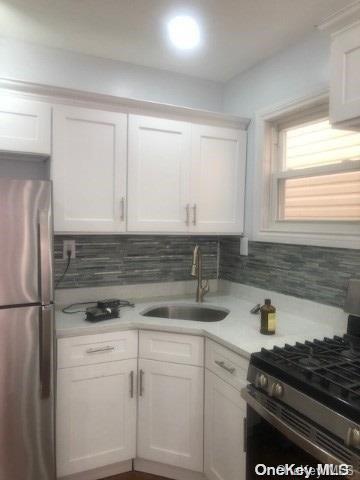 kitchen with white cabinetry, sink, and appliances with stainless steel finishes