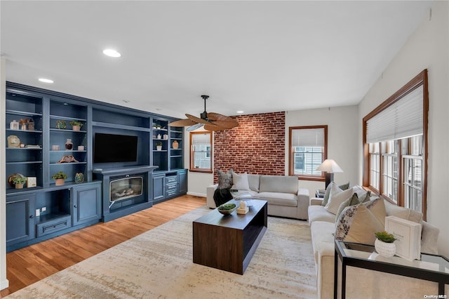 living room with ceiling fan and light wood-type flooring