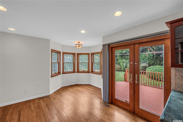 entryway with light hardwood / wood-style floors and french doors