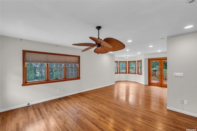 spare room featuring french doors, ceiling fan, and light hardwood / wood-style floors