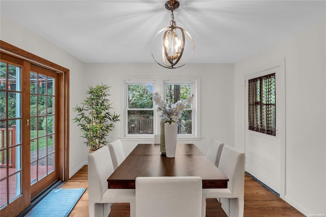 dining room with an inviting chandelier and wood-type flooring