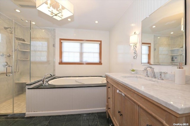 bathroom featuring tile patterned flooring, shower with separate bathtub, and vanity