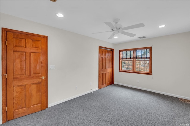 unfurnished bedroom featuring ceiling fan, a closet, and carpet flooring