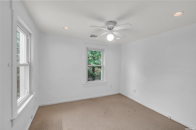 spare room featuring carpet floors and ceiling fan