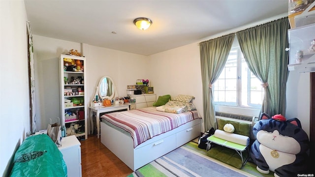 bedroom with hardwood / wood-style flooring