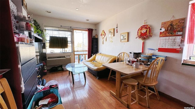 interior space featuring a wall mounted air conditioner and hardwood / wood-style floors