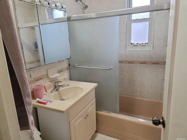 bathroom with vanity and enclosed tub / shower combo