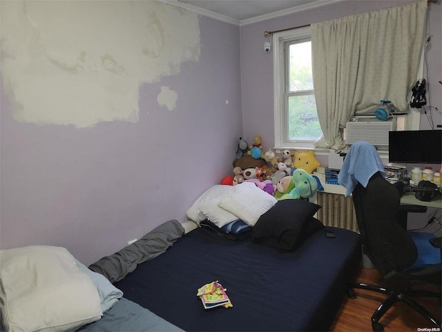 bedroom featuring wood-type flooring and crown molding