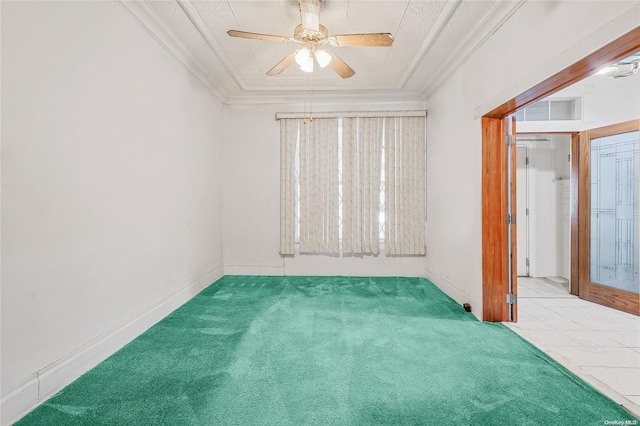 carpeted empty room with ceiling fan and crown molding