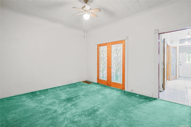 unfurnished room with carpet, french doors, a textured ceiling, and ceiling fan