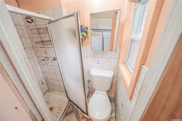 bathroom with toilet, tile walls, and a shower with shower door