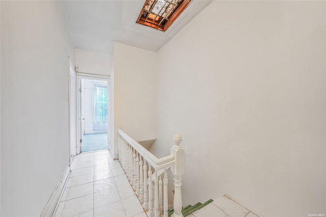 corridor featuring light tile patterned floors