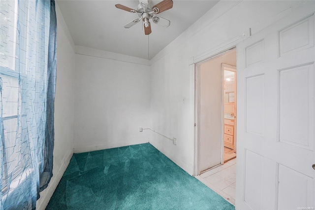 carpeted empty room featuring ceiling fan