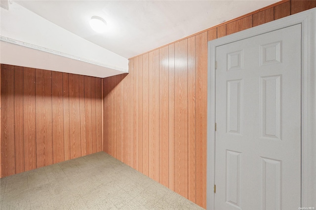 bonus room featuring wooden walls