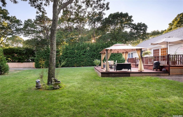 view of yard with a gazebo and a wooden deck