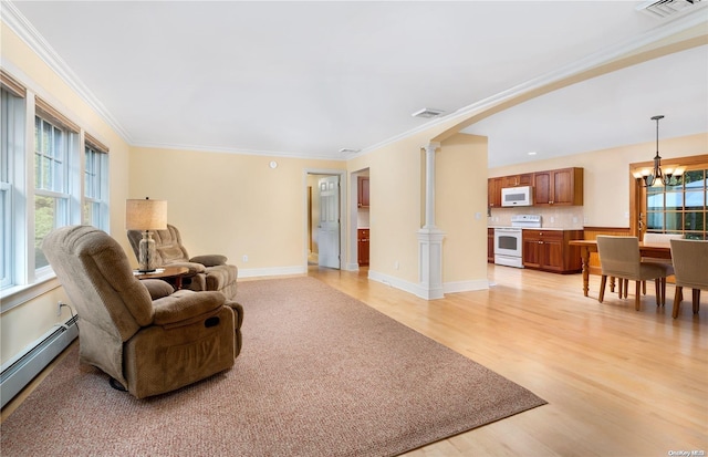 living room featuring a chandelier, light hardwood / wood-style floors, crown molding, and a baseboard heating unit