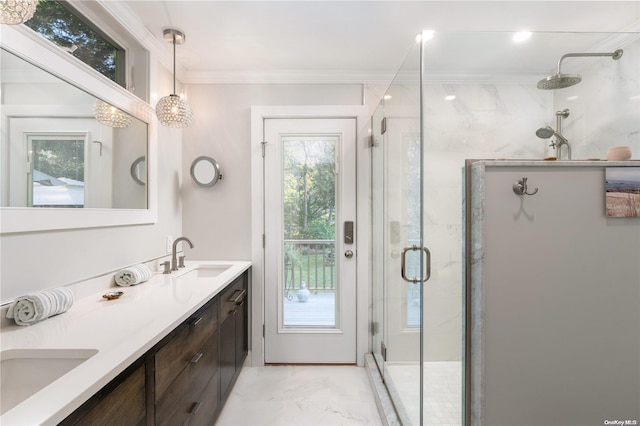 bathroom with vanity, a shower with shower door, and crown molding