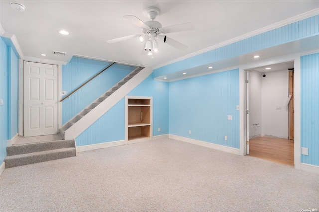 unfurnished living room featuring ceiling fan, carpet floors, and crown molding