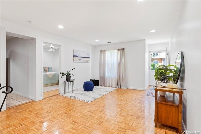 exercise area featuring ceiling fan and light parquet floors