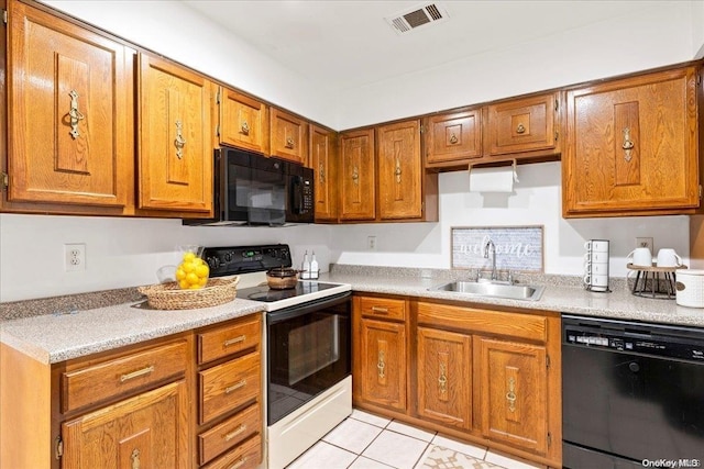 kitchen featuring sink, light tile patterned floors, and black appliances