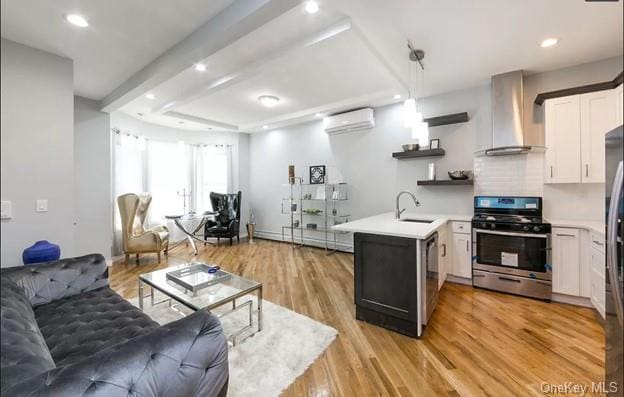 interior space featuring an AC wall unit, sink, and light wood-type flooring